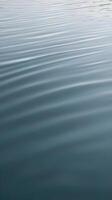 Vertical background of soft ripples on a calm water surface, creating a tranquil effect with copy space. photo
