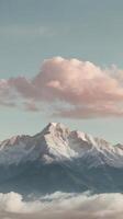 A vertical scene of a distant mountain ridge with soft, hazy clouds, gentle pastel hues, and open sky for copy space. photo
