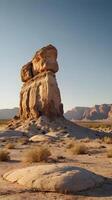 A serene vertical scene showcasing unique desert rocks under gentle lighting, framed by an expansive sky perfect for text placement. photo