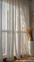 Close-up of vertical folds of sheer white curtains softly lit by natural daylight, creating a tranquil atmosphere with copy space. photo
