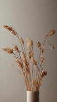 A vertical composition of dried flowers arranged against a simple neutral backdrop, providing a clean, minimalist style and room for copy. photo