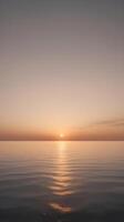 A tranquil vertical view of a sunset with warm hues fading into a serene open sky, providing clear space for text. photo