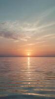 A peaceful vertical view of warm sunset tones mirrored on calm water, with ample room for text placement. photo