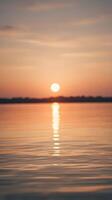 A vertical composition of soft sunset hues reflecting on quiet water, evoking calmness with open space for text. photo