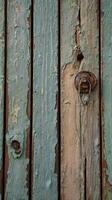 A vertical close-up of an old wooden shutter with peeling paint, offering rich textures and space for text placement. photo
