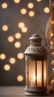 A vertical shot of a softly glowing lantern against a blurred neutral backdrop, offering plenty of space for text. photo