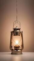A serene vertical image of a glowing lantern hanging against a gentle, blurred background, with clear space for copy. photo