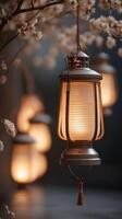 A vertical background of a glowing lantern hanging quietly against a blurred neutral background, with ample copy space. photo