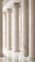 A vertical image of polished marble columns in soft neutral tones, with gentle reflections and ample space for text. photo