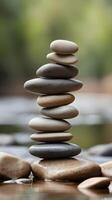 A vertical composition of smooth river stones stacked together, with a muted, blurred background and clear space for text. photo