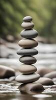 A vertical arrangement of smooth river stones set against a blurred natural backdrop, providing ample space for text. photo