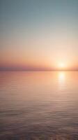 A vertical composition showcasing a seamless color gradient on the horizon, creating a peaceful, minimalist background. photo