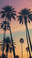 A vertical composition of palm tree silhouettes set against a tranquil twilight sky, offering blank space for text. photo