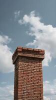 High-resolution image of a rustic brick chimney with a neutral sky backdrop, ideal for overlaying text. photo