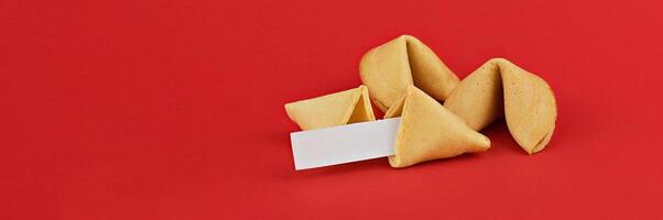 Fortune cookies on red background, featuring blank fortune slip, perfect for customization and personal messages with copy space photo