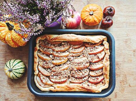 Top view on cooked open apple pie with nuts and cinnamon photo