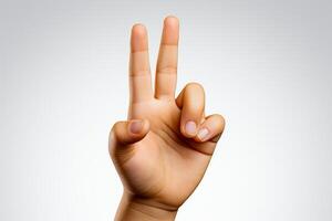 Child's hand showing the number 2 with fingers isolated on white background.Freedom sign.Close up view photo
