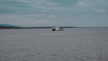 Vessel Sailing on a Calm River Surrounded by a Scenic Landscape photo