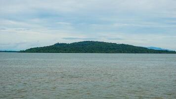 Scenic View of a Remote Island Surrounded by Calm Ocean Waters photo
