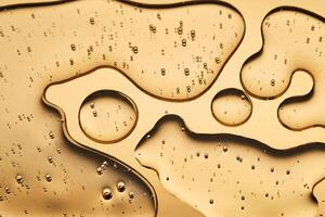 The beautiful texture of the cosmetic serum on a gold background that takes up most of the photo. photo