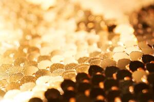 Abstract festive gold background made of sequins. photo