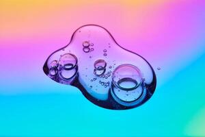 A drop of cosmetic serum on a multicolored background in shades of blue and lilac. photo
