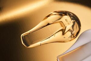 Tasty texture of cosmetic gel on a golden background. photo