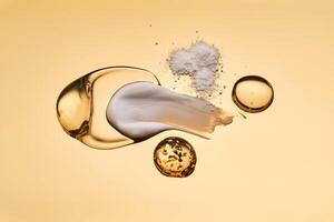 Textures of different cosmetic products on a gold background. photo