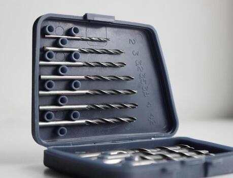 Opened lid of set box for drill bits storage studio isolated stock photo