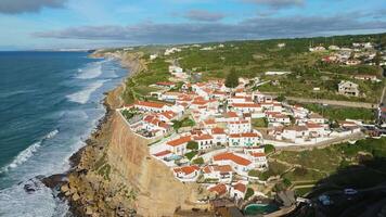 Azenhas do Mar Village on Sunny Day. Cliffs and Waves of Atlantic Ocean. Portugal. Aerial View. Moving Backwards, Tilt Up video