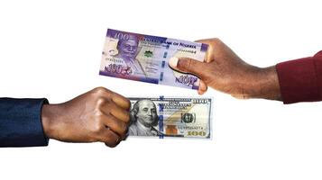 Nigerian Naira USA Dollar currency pairing.Black African hands holding exchanging comparing two bank notes. Nigeria versus USA. Weighing Currencies against each other. Exchange rate photo