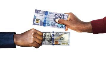 Ghanaian cedi USA Dollar currency pairing.Black African hands holding exchanging comparing two bank notes. Ghana versus USA. Weighing Currencies against each other. Exchange rate photo