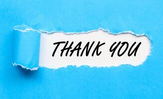 Torn paper with text Thank you message on blue backgrounds. photo