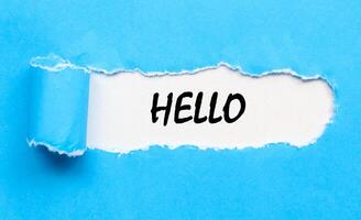 Torn paper with text hello message on blue backgrounds. Concept hello word. photo