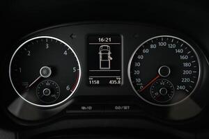 Close up view of a car's instrument panel displaying speed RPM and trip information photo