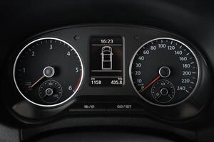 Close up of a car's instrument panel displaying speed RPM and trip information photo