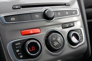 Modern car dashboard with climate and audio controls photo