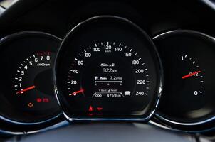 Close up view of a car's instrument panel showing speedometer tachometer and fuel gauge photo