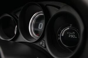 Close up of a car's dashboard displaying fuel level and mileage photo