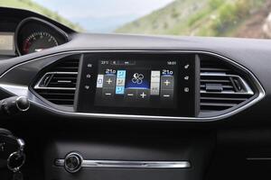 Modern car interior detail climate control and infotainment screen photo
