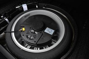 Spare tire and subwoofer in a vehicle's trunk photo