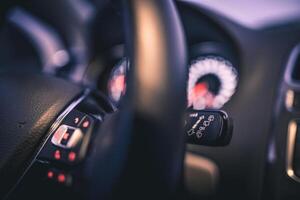 Close up of car's interior controls focusing on the steering wheel and wiper controls photo