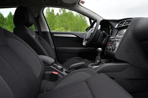 Interior view of a car with black leather seats and a modern dashboard photo