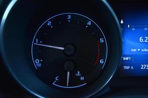 Close up of a car's instrument panel showing the tachometer speedometer and fuel gauge photo