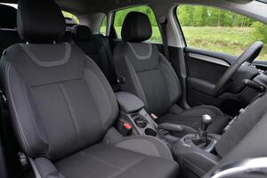 Modern car interior with black fabric seats and center console photo