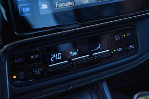 Modern car climate control panel showing temperature and settings photo