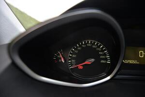 Close up of a car's dashboard with speedometer fuel gauge and odometer photo