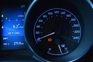Car dashboard showing speed fuel level and trip information photo