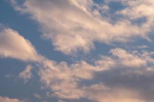 Soft pastel clouds drift across a vast blue sky A tranquil and serene scene photo