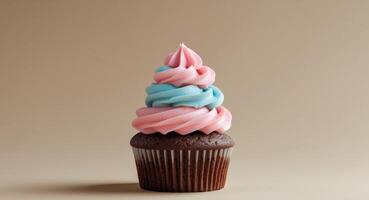 Chocolate cupcake with pink and blue swirled frosting on beige backgroundChocolate cupcake with pink and blue swirled frosting on beige background. photo